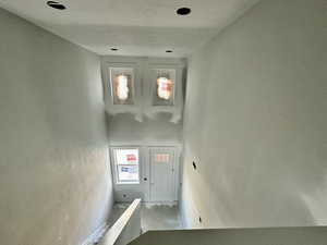 Staircase featuring a towering ceiling