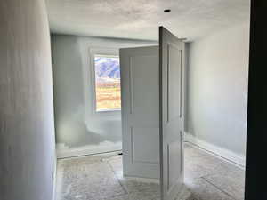 Bathroom featuring baseboards and a textured ceiling