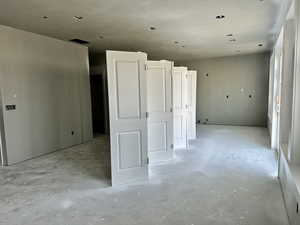 Unfurnished room with concrete flooring