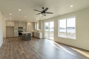 Kitchen with recessed lighting, a center island, appliances with stainless steel finishes, dark wood-type flooring, and ceiling fan