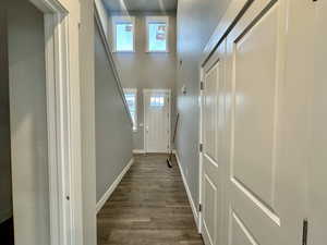 Doorway to outside featuring wood finished floors and a high ceiling