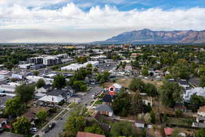 Aerial view of property's location featuring nearby suburban area and mountains