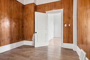 Spare room with wooden walls and wood finished floors