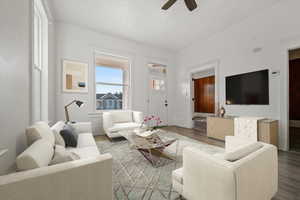 Living room featuring wood finished floors and a ceiling fan