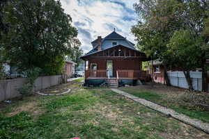 Back of property with a fenced backyard and a chimney