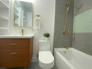 Bathroom featuring shower / washtub combination, vanity, and tile patterned floors