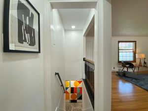 Hall featuring an upstairs landing, recessed lighting, and wood finished floors