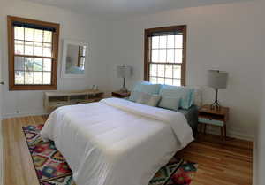 Bedroom featuring light wood finished floors and baseboards