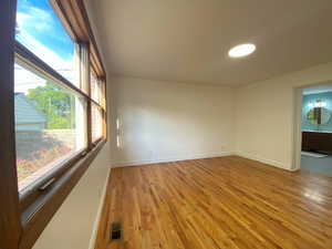 Spare room featuring light wood-style floors and baseboards