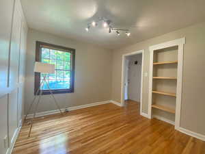 Unfurnished bedroom with light wood-style floors and a closet