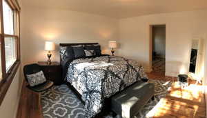 Bedroom featuring wood finished floors and baseboards