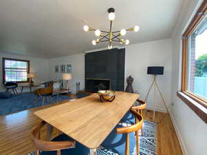 Dining area featuring wood finished floors, a textured ceiling, ornamental molding, and a chandelier