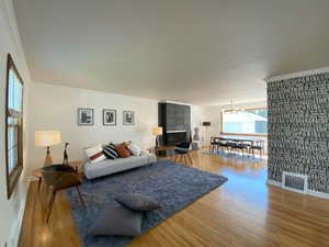 Living area featuring wood finished floors and a chandelier