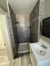Full bathroom featuring vanity, a shower stall, and light wood-type flooring