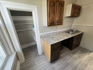 Laundry area featuring light wood finished floors and a sink