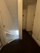 Stairway featuring a textured wall and carpet floors