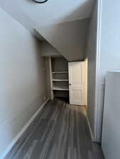 Unfurnished bedroom with dark wood-style floors and a closet