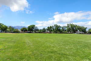 View of community with a mountain view and an area for sports