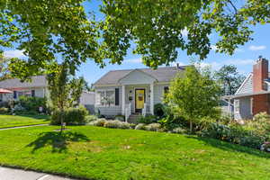 Bungalow featuring a front lawn and roof with shingles