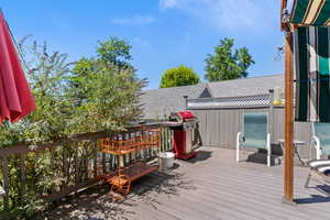 Wooden deck featuring area for grilling