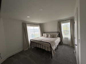 Bedroom featuring dark colored carpet and recessed lighting