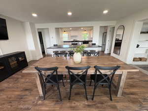 Dining area with recessed lighting and dark wood-type flooring
