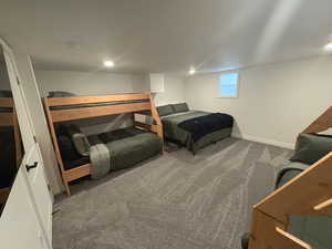 Carpeted bedroom featuring baseboards