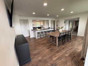 Dining space with recessed lighting and dark wood-style floors