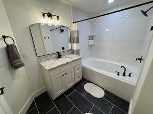 Full bath with vanity and shower / bath combination with curtain