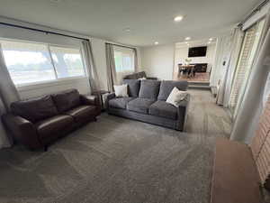 Carpeted living room featuring recessed lighting