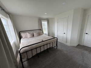 Carpeted bedroom with baseboards and recessed lighting