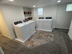 Laundry room with washer and dryer, dark stone finish flooring, dark colored carpet, and recessed lighting