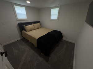 Bedroom with carpet flooring, multiple windows, and recessed lighting
