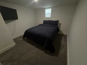 Carpeted bedroom featuring baseboards