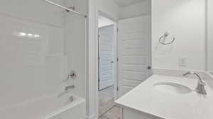 Bathroom with shower / washtub combination and vanity