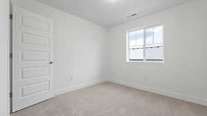 Empty room with light carpet and baseboards