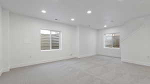 Unfurnished room with recessed lighting and light colored carpet