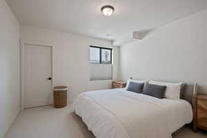 Bedroom featuring carpet floors and a textured ceiling