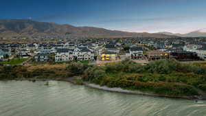 View of property location featuring nearby suburban area and a water and mountain view