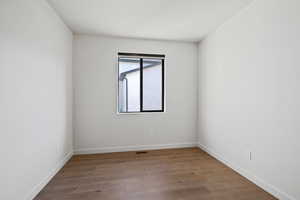 Empty room featuring light wood-type flooring