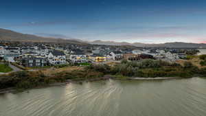 Water view with nearby suburban area and a mountain backdrop