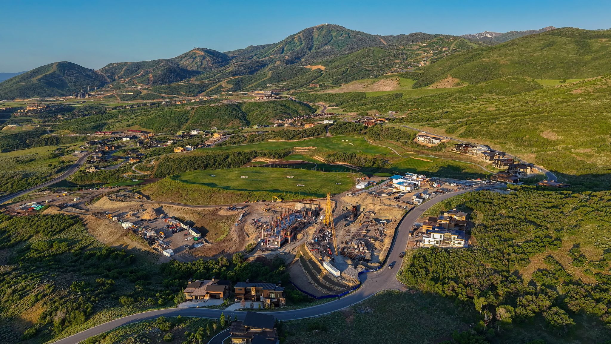 Aerial view of property's location with a mountain backdrop