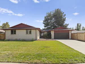 View of front facade with driveway, brick siding, and a garage