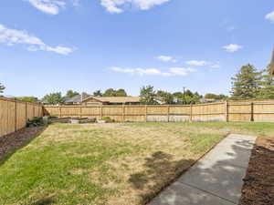Fenced backyard with a garden