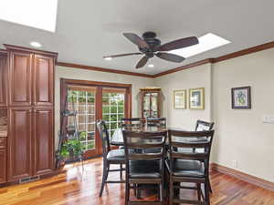 Dining area with light wood-type flooring, ornamental molding, recessed lighting, and ceiling fan with French doors leading to rear patio