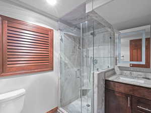 Full bathroom with vanity and a marble finish shower
