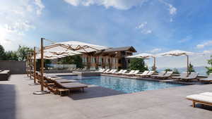 Community pool featuring a mountain view, an in-ground hot tub, and a patio