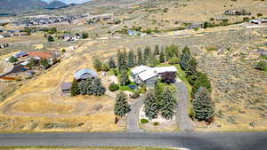 Aerial view of property and surrounding area featuring mountains and rural landscape