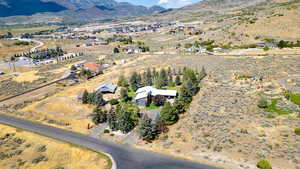 Aerial view of property's location featuring a mountain backdrop and rural landscape