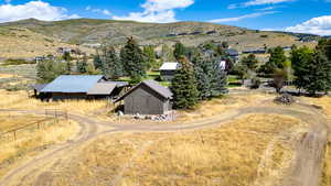 Aerial view of property and surrounding area featuring a mountain backdrop